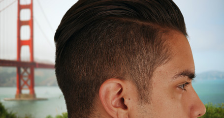 Obraz premium Close up of Latino male with cool undercut standing near Golden Gate Bridge