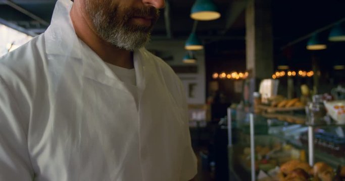 Male chef maintaining records on tablet 4k