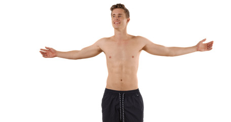 Fototapeta na wymiar Attractive white male in swim shorts spreading arms in studio for copyspace