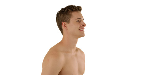 Fototapeta premium Profile view of handsome Caucasian male looking out at imaginary ocean in studio