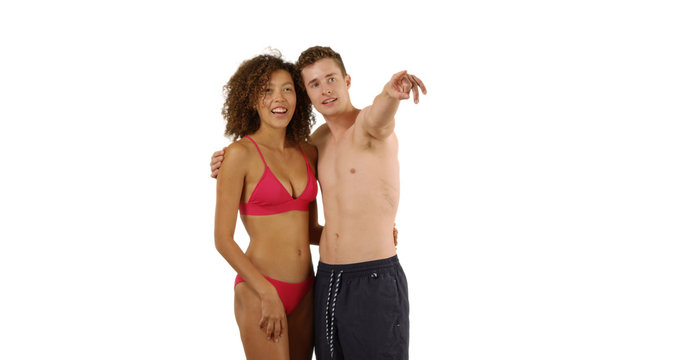 Happy millennial couple looking at imaginary ocean together on white background