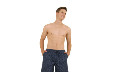 Happy Caucasian male relaxing in swim shorts on white background for copy space