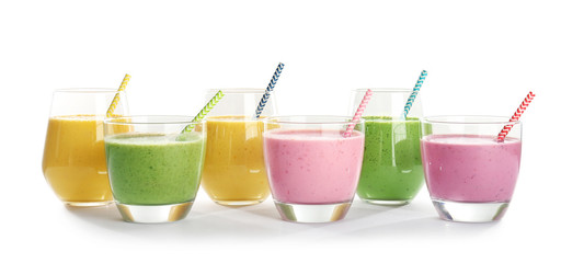 Glasses with fresh tasty smoothies on white background