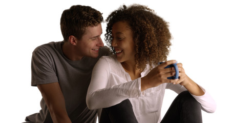 Happy multiethnic couple drink coffee on white background with copyspace
