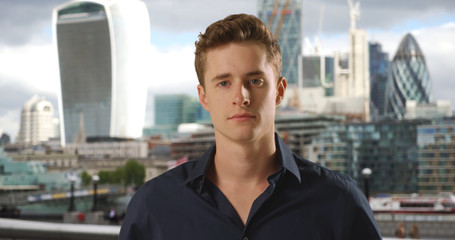 Portrait of confident businessman with urban skyline in background