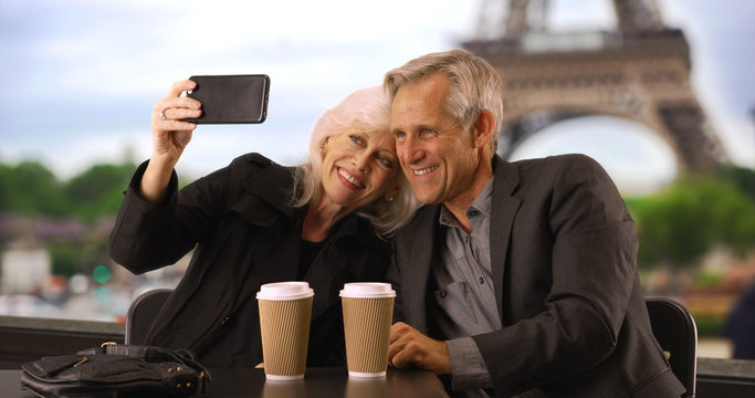 Happy mature couple taking a selfie in Paris