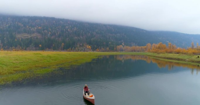 Man rowing a boat on a lake 4k