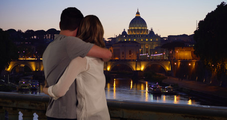 Young married couple enjoy view of Rome skyline at night