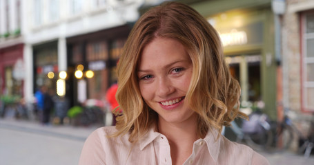 Casual portrait of beautiful Caucasian girl in her 20s standing outdoors