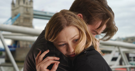 Close up of young married London couple embracing near the Tower Bridge