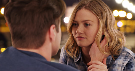 Over the shoulder shot happy millennial couple chatting outdoors at night
