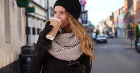 Young woman with her coffee in European urban setting