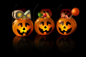 Jack o lantern with candies for halloween 2018 on a black background