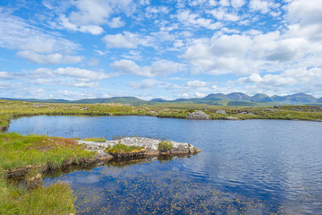 Panorama of mountains, marshy land and heathland of Connemara National Park in summer