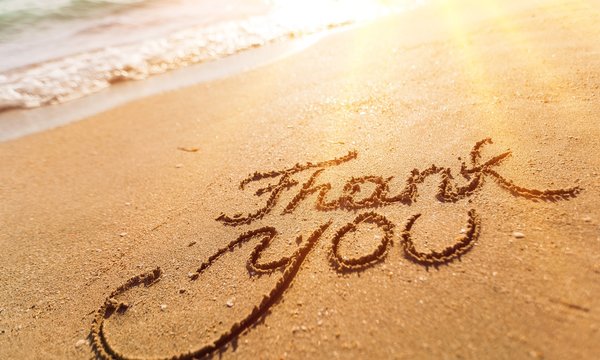 Thank you sign on sandy sea beach