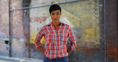 Casual portrait of black woman gardener smiling at camera outside