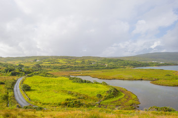 Fototapeta premium Panorama of mountains, marshy land and heathland of Connemara National Park in summer