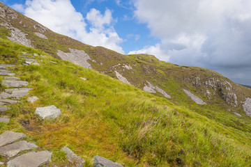 Panorama of mountains, marshy land and heathland of Connemara National Park in summer