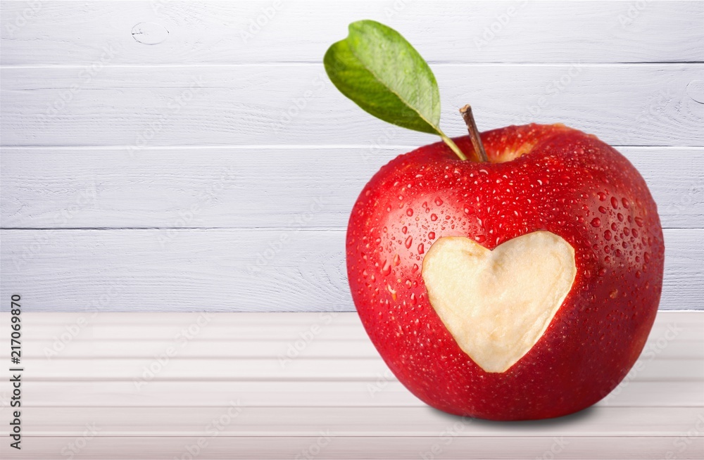 Wall mural red apple with a heart shaped on