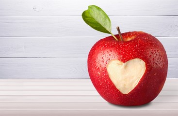 Red apple with a heart shaped on