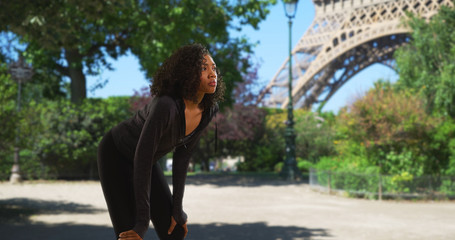 Black woman athlete in Paris taking a break to catch her breath