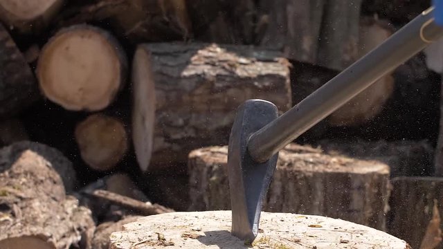 Wood chopping with a hatchet close-up slow motion