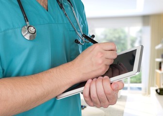 Female doctor using digital tablet, close up