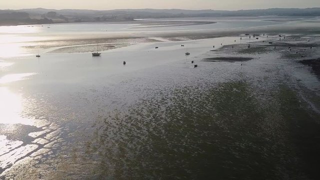 Aerial shot of sail boats moored in the River at Dusk.