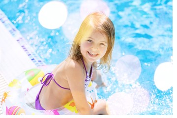 Beautiful little girl sunning at the pool