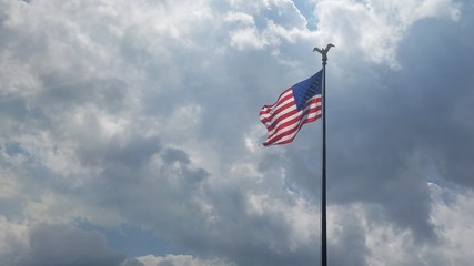 Flag flowing in breeze clouds