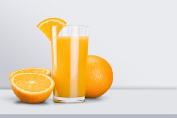 Glass of delicious orange juice on table