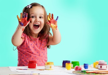 Naklejka na ściany i meble Little girl showing painted hands on background