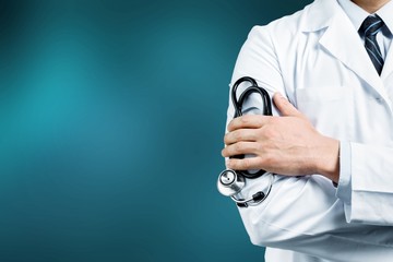 Young man doctor holding stethoscope