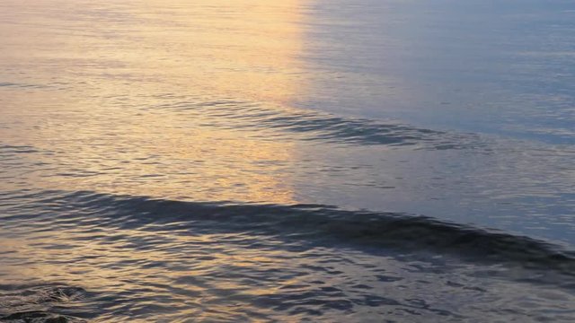 Beautiful sunset. Oppositions of red and blue. The sky is divided in half. A smooth line runs along the sea. The sun is behind the clouds.