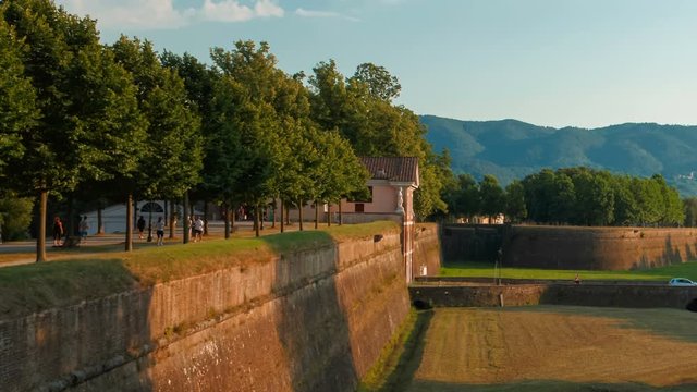 Telephoto panning shot of the beautiful city walls of Lucca, Tuscany, italy and spectacular hillside scenery. Lucca is famous for its intact city walls dating from the Renaissance era