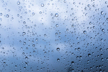 Water drops on clear plastic sheet. The sky is the backdrop