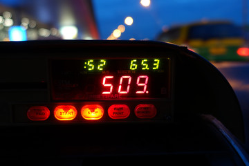 image of taxi meter and dashboard interior, view from backseats 