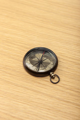 Fototapeta na wymiar vintage compass on the wood table