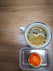 Top view of hot black coffee and chinese pastry dessert on wood table