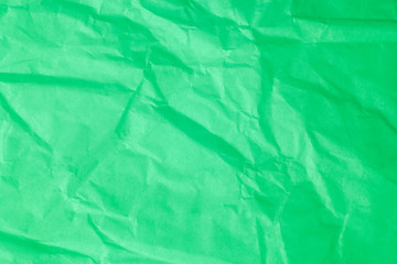Fototapeta premium Green crumpled paper background.