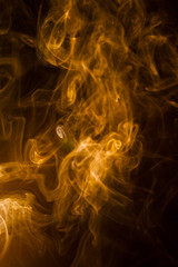 Gold smoke on black background.
