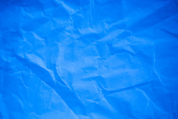 Crumpled blue paper background.