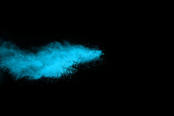 Fototapeta na wymiar Blue powder explosion on black background. Colored cloud. Colorful dust explode. Paint Holi.