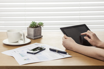 woman hand hold a tablet pc at the office