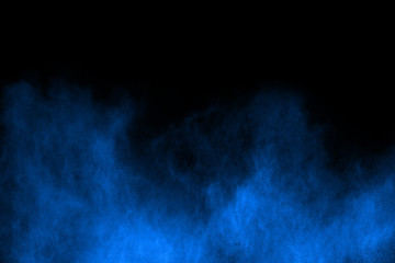 Blue powder explosion on black background. Colored cloud. Colorful dust explode. Paint Holi.