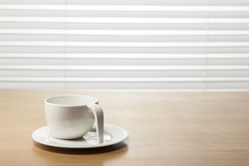 white coffee cup on the wood table at the office