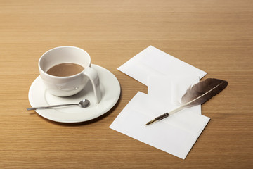 milk coffee with paper, feather pen on the wood table.