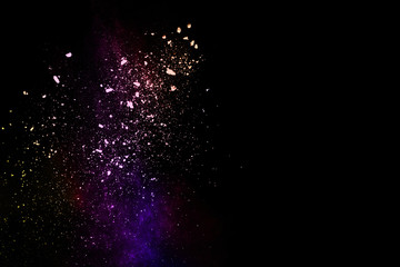Naklejka na ściany i meble abstract colored dust explosion on a black background.abstract powder splatted background,Freeze motion of color powder exploding/throwing color powder, multicolored glitter texture.