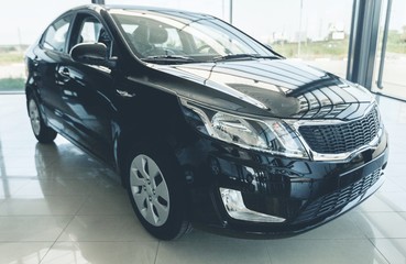 New shining beautiful cars stand near desk