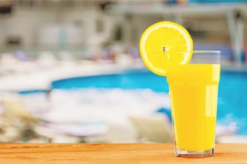 Orange juice on pool background